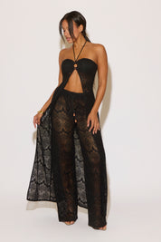 Woman wearing a black lace outfit on a white background
