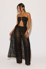 Woman wearing a black lace outfit on a white background