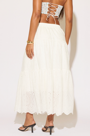 White lace-up top and skirt set on a plain background