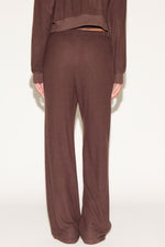 Brown sweatshirt and pants set on a white background