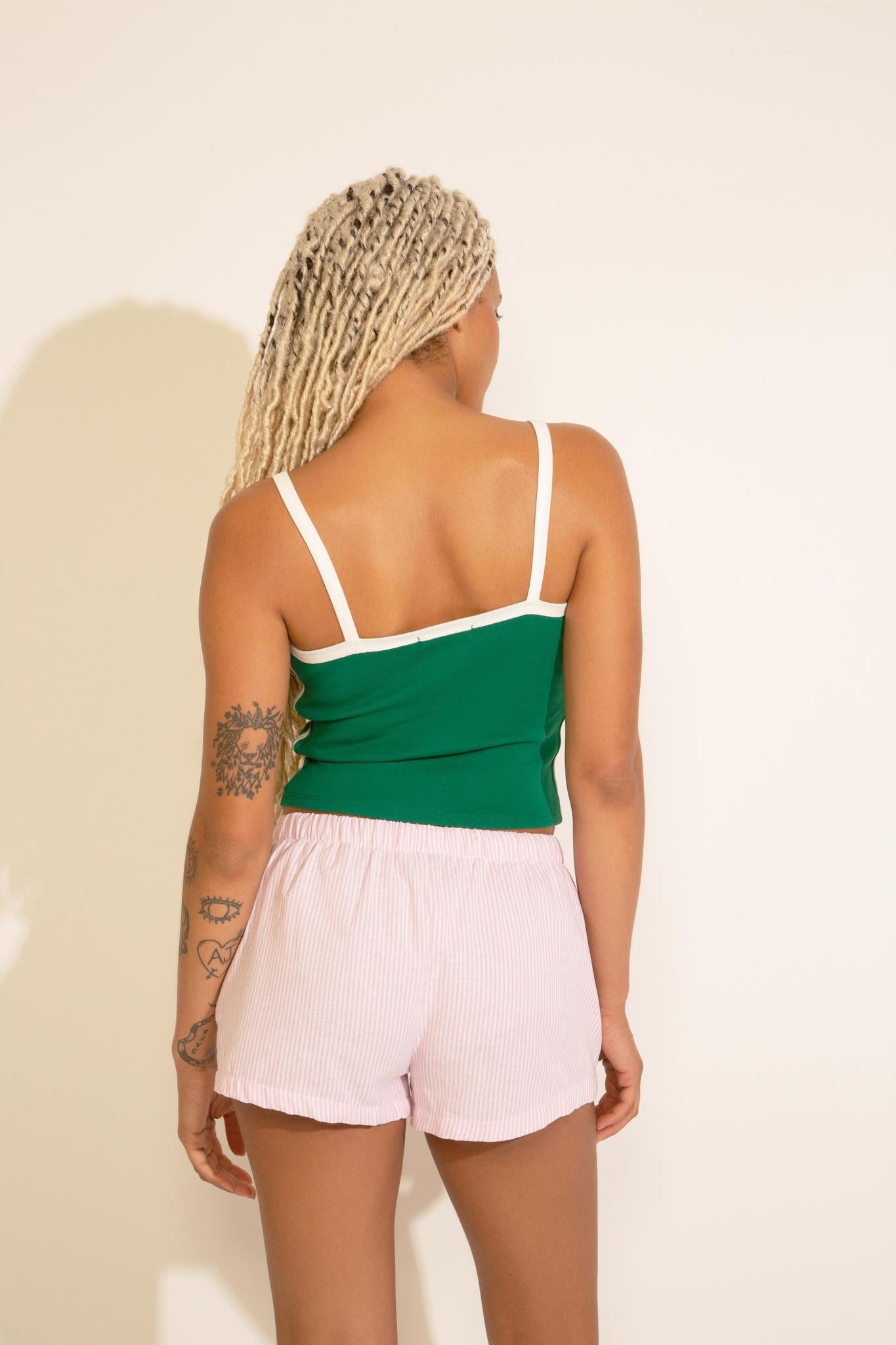 A green and white tank top with 'NEW YORK' text on the front, featuring contrast trim.