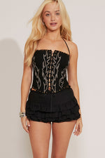 A tiered ruffle mini skirt in black with a black top