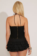 A tiered ruffle mini skirt in black with a black top