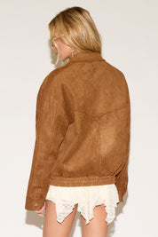 A women wearing a brown jacket in a white background.