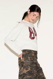 CONTRAST NUMBER 84 LONG SLEEVE CROPPED TOP