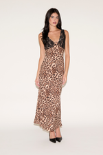 Woman wearing a leopard print dress with black lace details on a white background