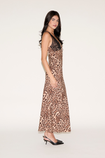 Woman wearing a leopard print dress on a white background