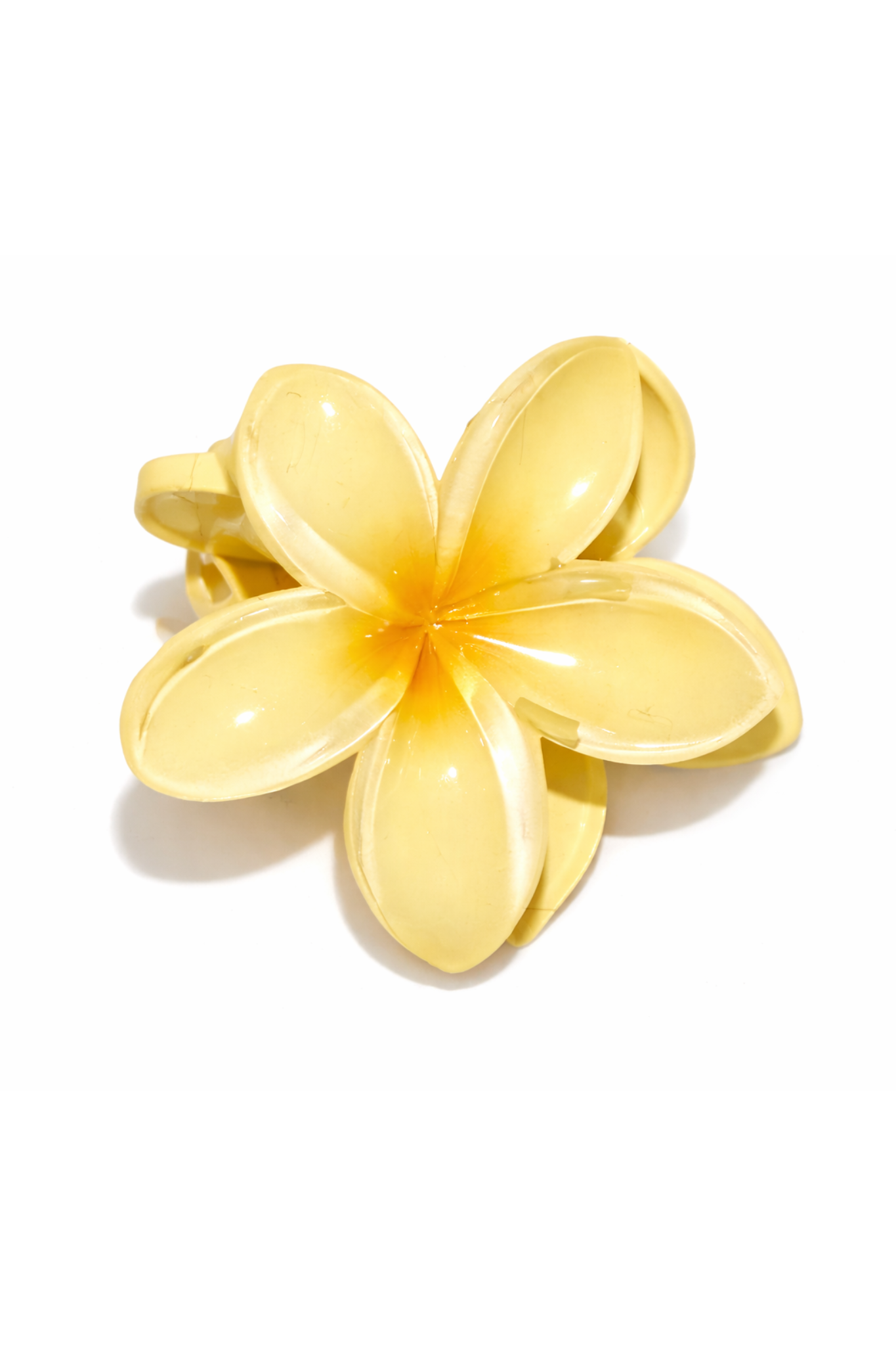 Yellow flower-shaped hair clip on a white background