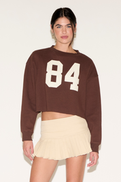 CONTRAST NUMBER 84 LONG SLEEVE CROPPED TOP