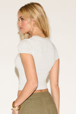 Model wearing a grey cropped short-sleeve t-shirt 
