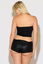 Model is wearing a black studded strapless pointed hem top with black shorts on a white background.