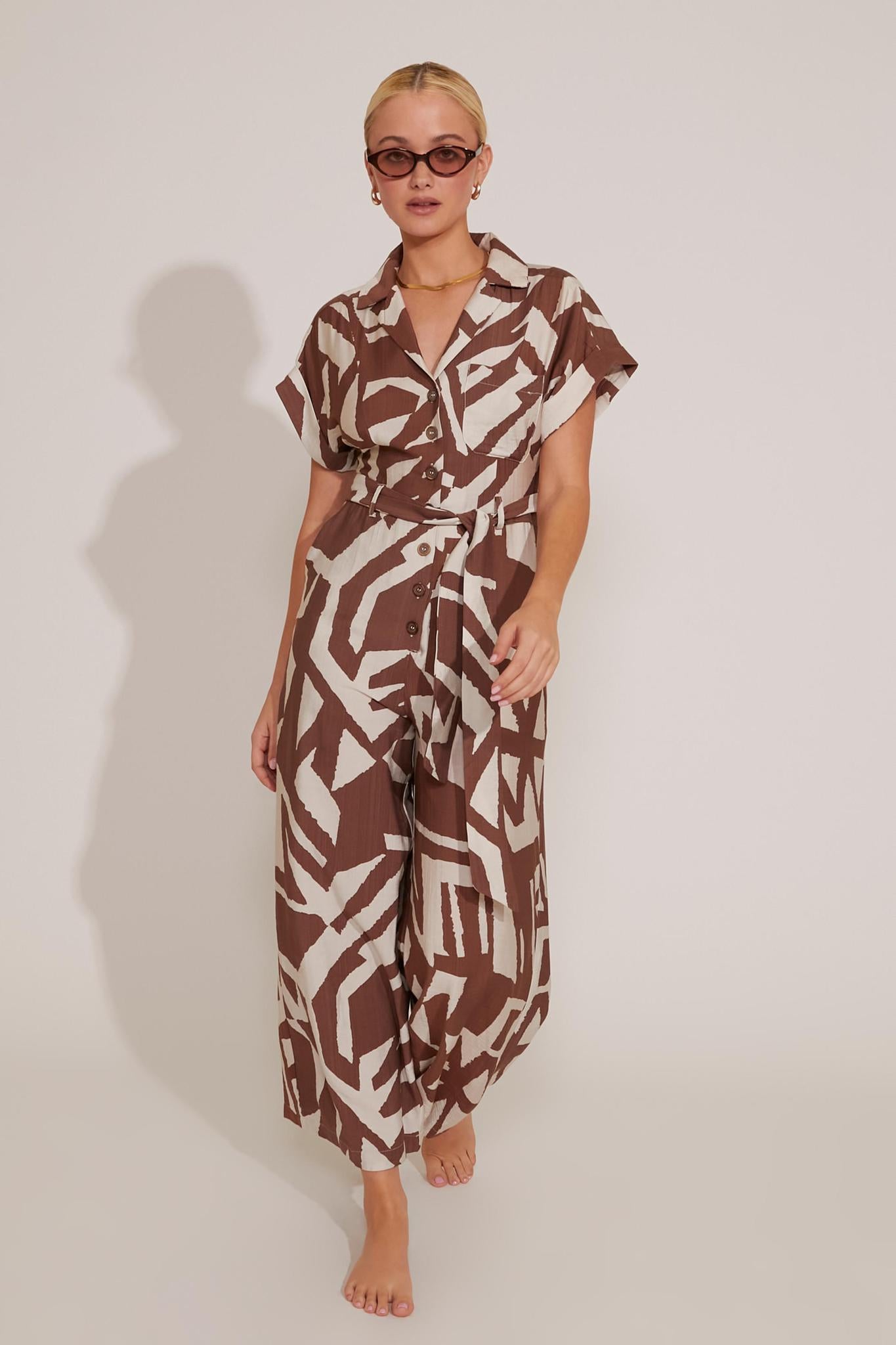 SHORT SLEEVED BUTTON-UP GRAPHIC PRINT WAIST-TIE JUMPSUIT