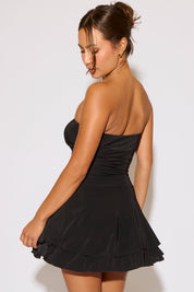 Woman wearing a black dress against a white background