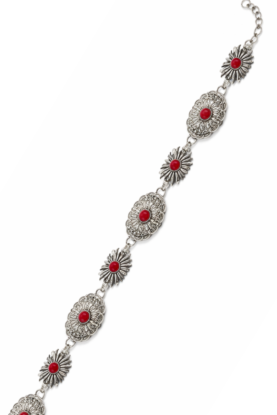 Decorative belt with red stones and silver patterns worn by a person in a white top and black pants.