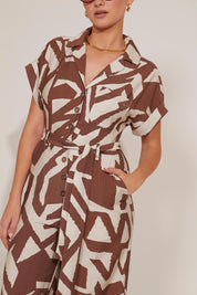 SHORT SLEEVED BUTTON-UP GRAPHIC PRINT WAIST-TIE JUMPSUIT