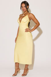 Woman wearing a yellow dress against a white background