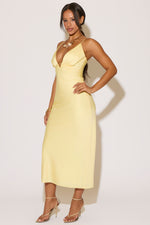 Woman wearing a yellow dress against a white background