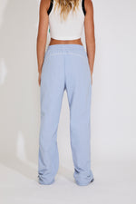 Light blue pants worn by a person on a white background