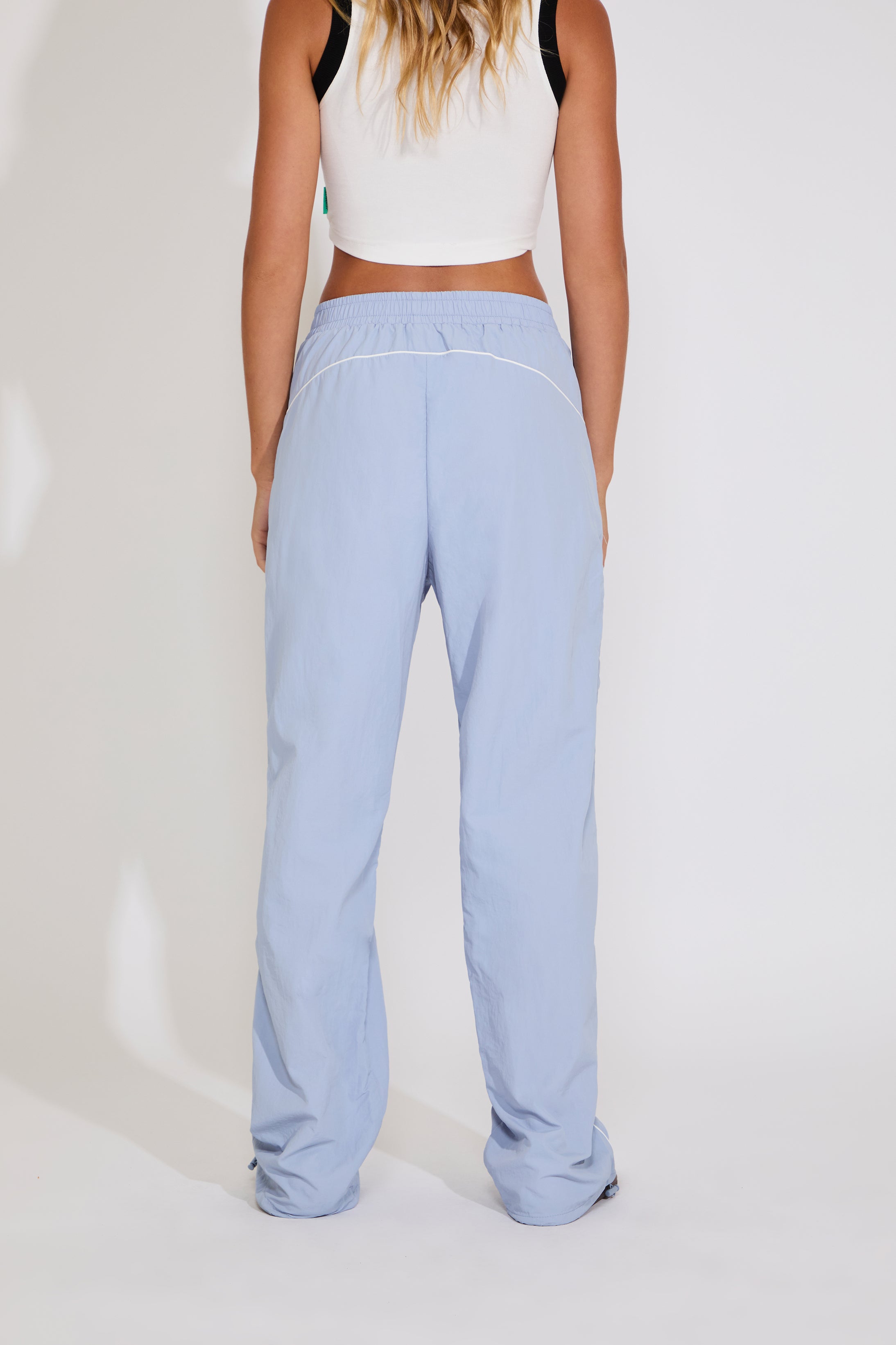 Light blue pants worn by a person on a white background