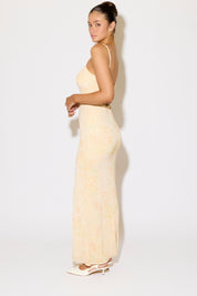 Woman wearing a strapless beige dress against a white background