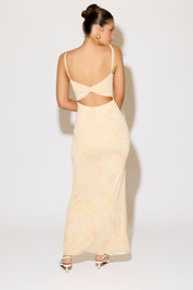 Woman wearing a beige evening gown with a white background