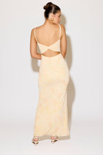 Woman wearing a beige evening gown with a white background