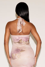 Woman wearing a floral dress with a plain background