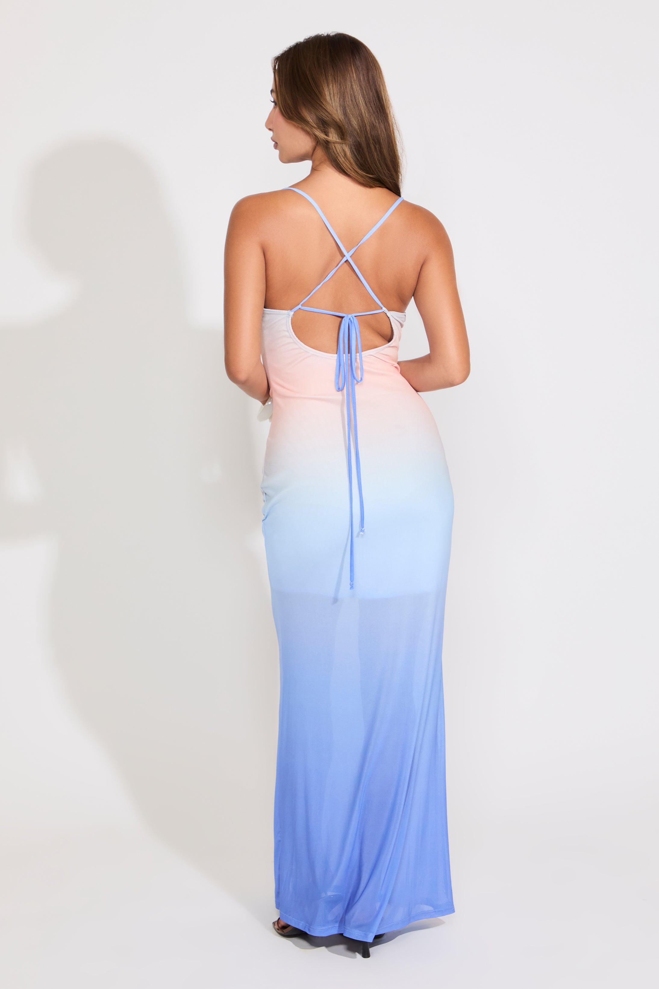Model is wearing a ombre mesh cowl neck mermaid maxi dress on a white background.