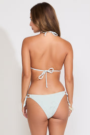 Model is wearing a dusty blue bikini set on a white background.