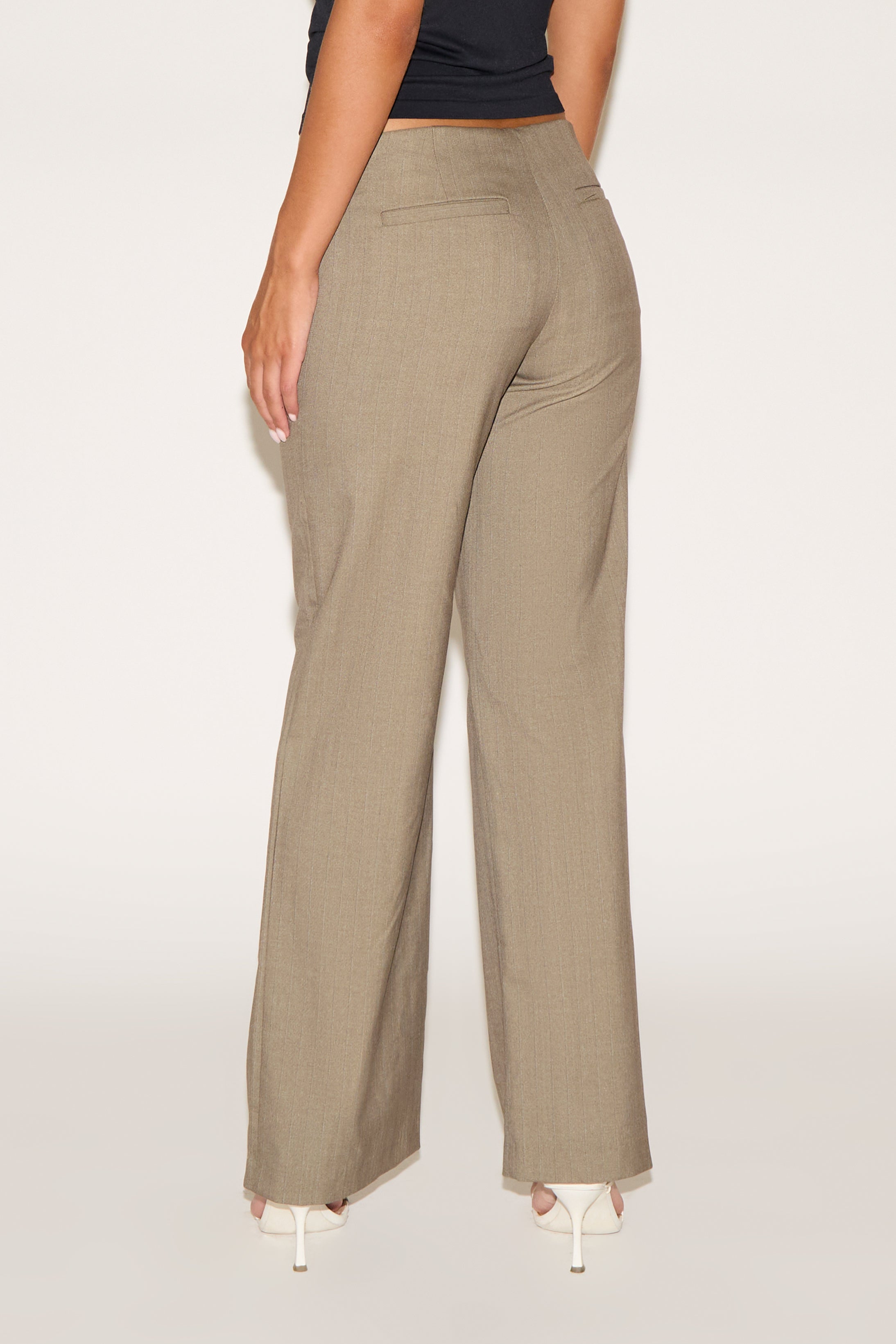 Beige wide-leg pants worn by a person on a white background