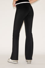 Black pants worn by a person on a white background