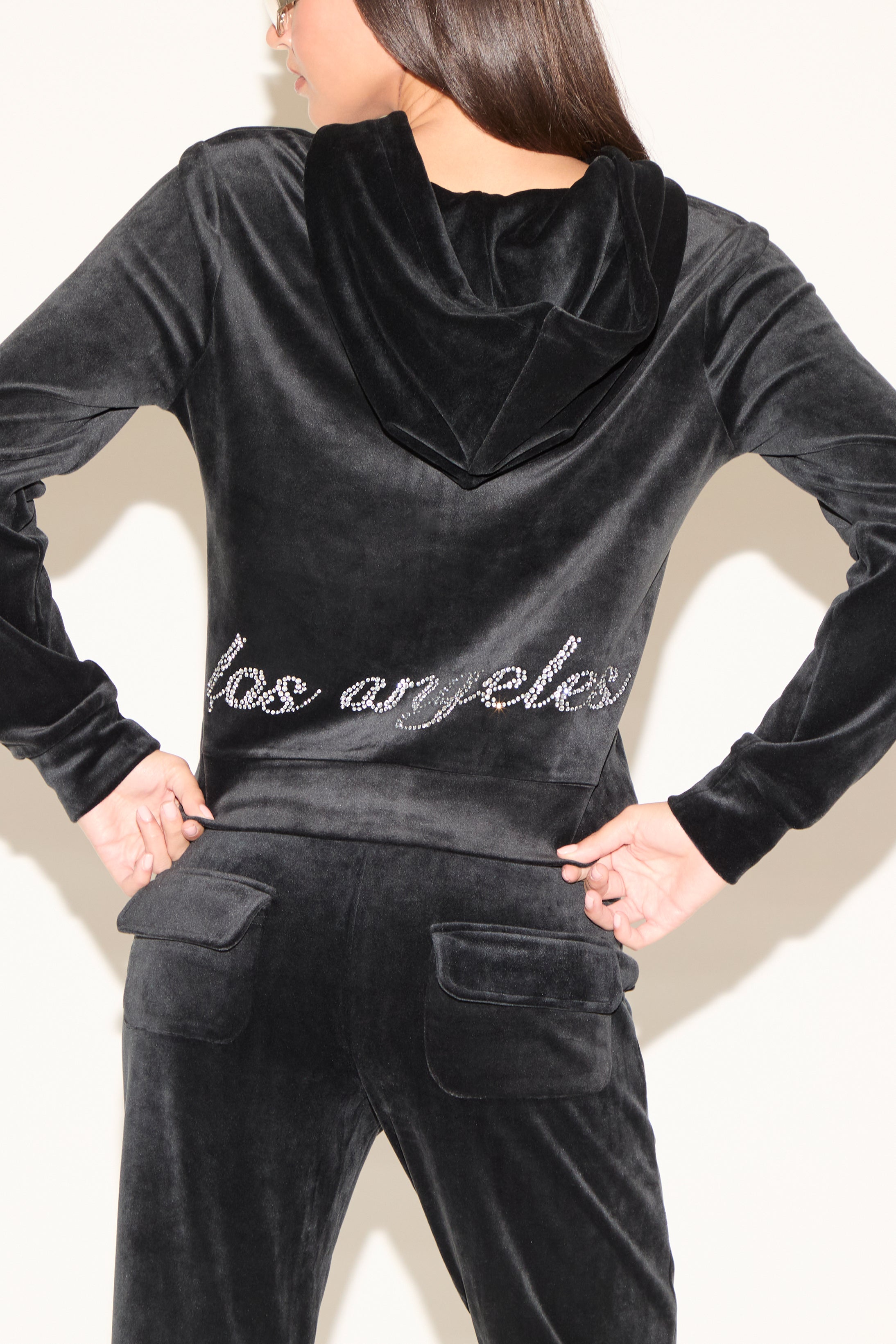 Black velour tracksuit with 'Los Angeles' text on a plain background