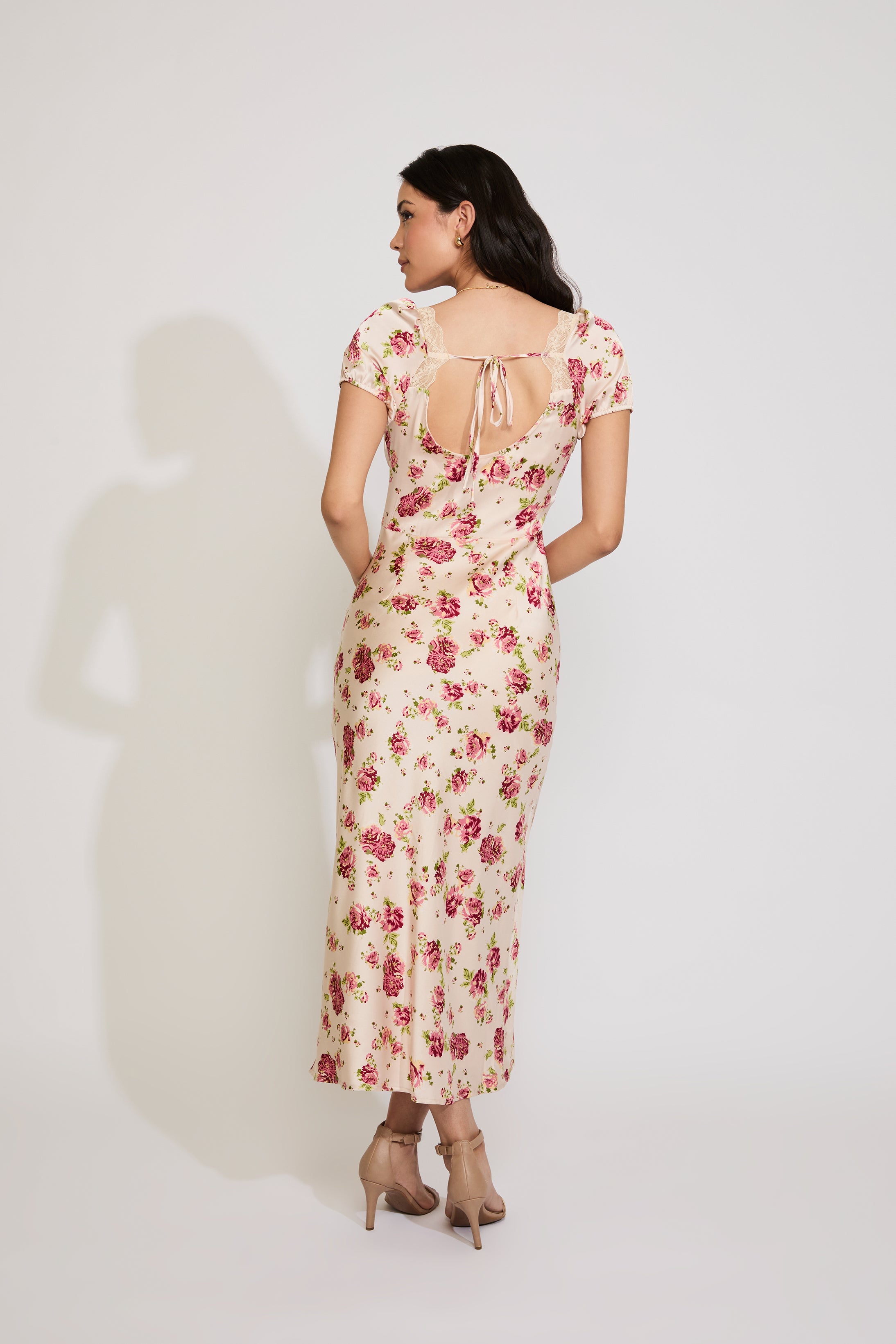 Woman wearing a floral dress with a white background