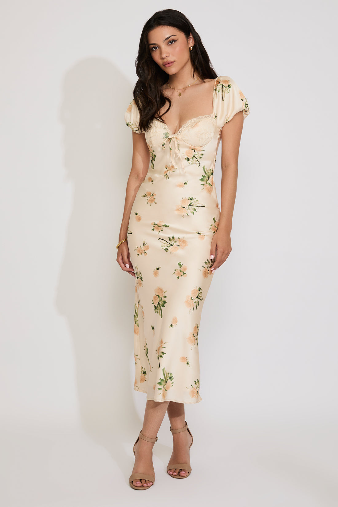 Woman wearing a floral dress against a white background