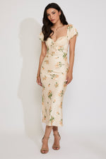 Woman wearing a floral dress against a white background