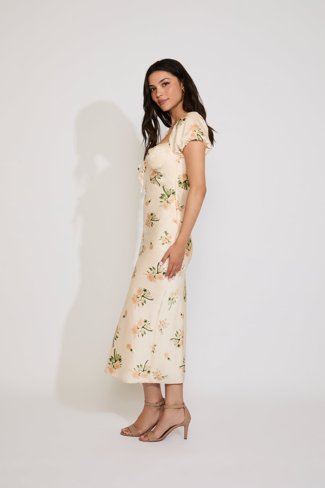 Woman wearing a floral dress against a white background