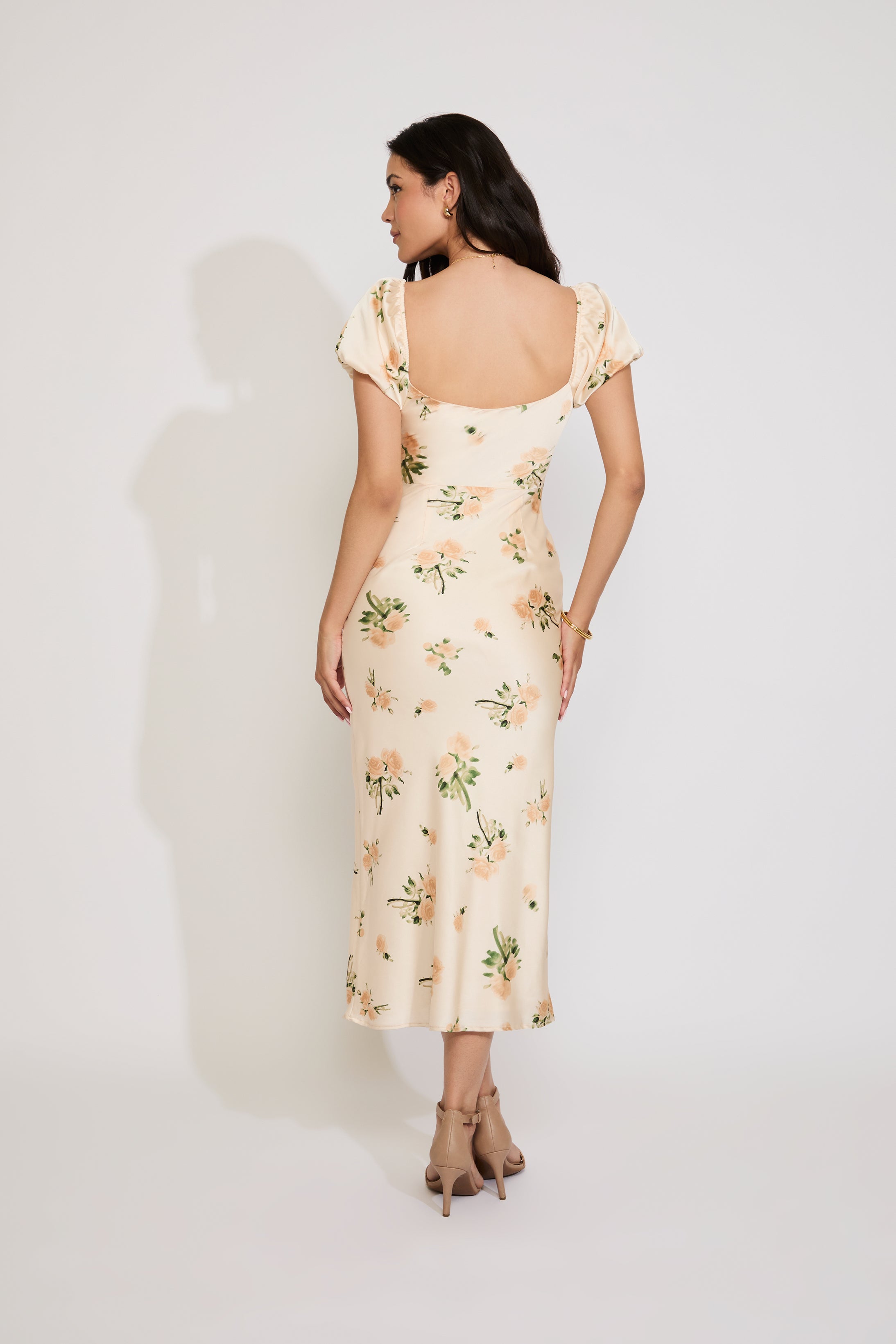 Woman wearing a floral dress against a white background