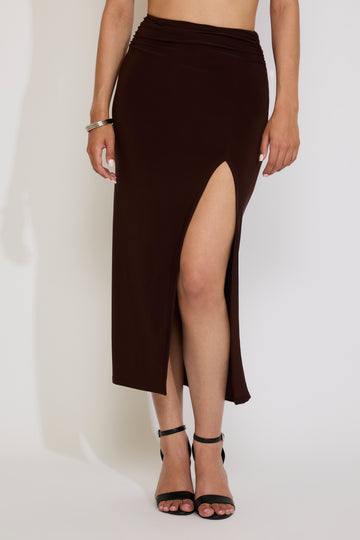 Brown slit skirt worn by a person on a white background