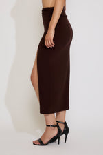 Brown slip skirt worn by a person on a white background