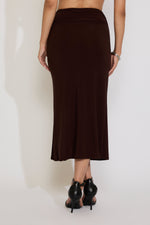 Brown skirt worn by a person on a white background