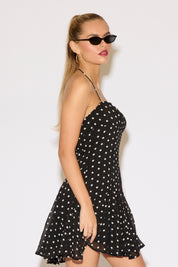 Model wearing a polka dot dress. 