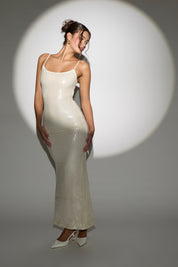 Women wearing a white glittery dress in a white background. 