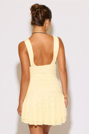 Woman wearing a yellow dress on a white background