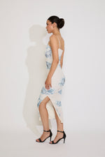 Woman wearing a floral dress with a white background