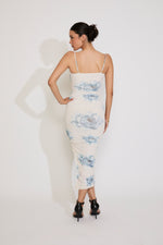 Woman wearing a floral dress against a white background