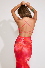 Model is wearing an abstract floral cross back ruched maxi dress on a white background.