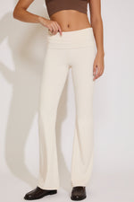 White pants worn by a person on a white background