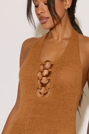 Brown halter top with cut-out design on a plain background