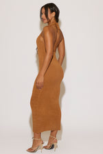 Woman wearing a brown dress against a white background