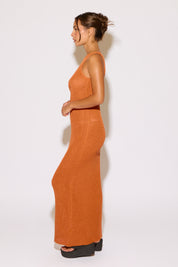 Woman wearing an orange dress on a white background